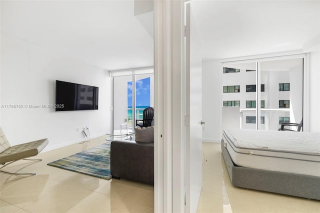 6365 Collins Ave Unit 805, Miami Beach, FL 33141 - tiled bedroom with floor to ceiling windows and baseboards