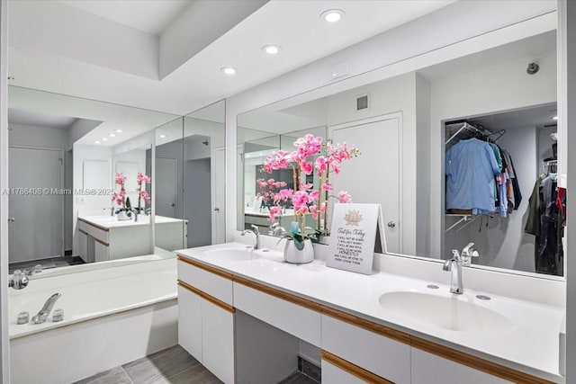 3400 192nd St Unit 1606, Aventura, FL 33180 - bathroom with double vanity, a garden tub, recessed lighting, and a walk in closet