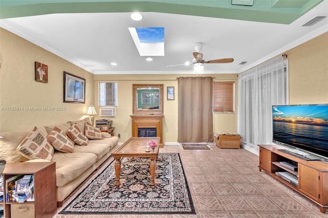 14898 Wildflower Ln Unit 0, Delray Beach, FL 33446 - living area featuring a skylight, crown molding, a ceiling fan, cooling unit, and a glass covered fireplace