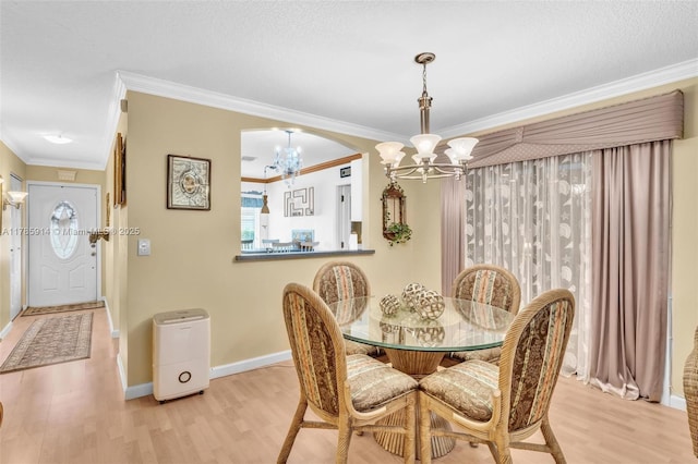 14898 Wildflower Ln Unit 0, Delray Beach, FL 33446 - dining area featuring a chandelier, wood finished floors, ornamental molding, and baseboards