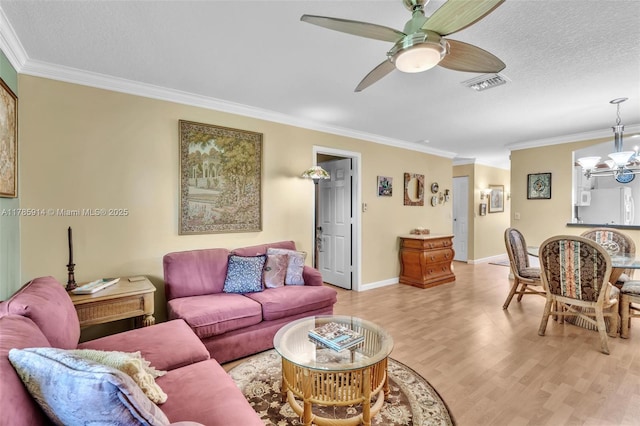 14898 Wildflower Ln Unit 0, Delray Beach, FL 33446 - living room featuring crown molding, ceiling fan, light wood-style floors, a chandelier, and baseboards