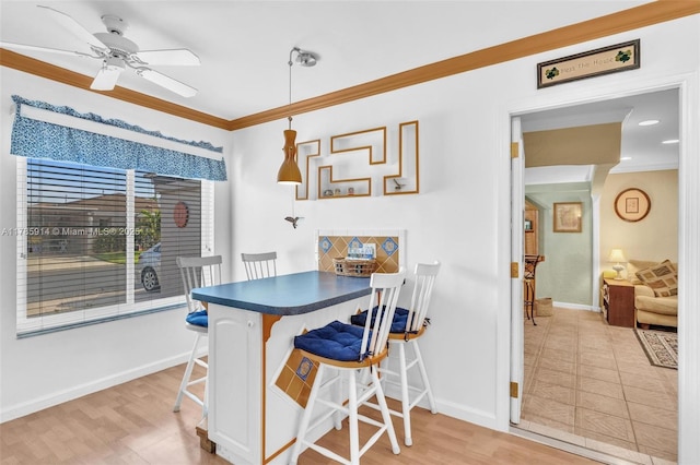 14898 Wildflower Ln Unit 0, Delray Beach, FL 33446 - dining room with ornamental molding, baseboards, a ceiling fan, and light wood-style flooring