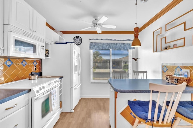 14898 Wildflower Ln Unit 0, Delray Beach, FL 33446 - kitchen with white appliances, tasteful backsplash, light wood-style floors, white cabinets, and ornamental molding