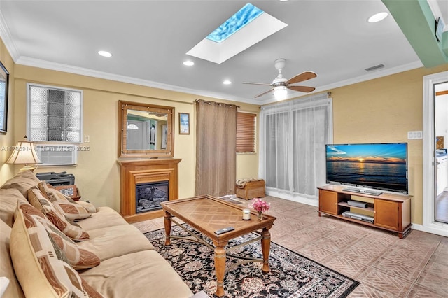 14898 Wildflower Ln Unit 0, Delray Beach, FL 33446 - living room with a skylight, a glass covered fireplace, ornamental molding, recessed lighting, and ceiling fan