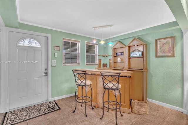 14898 Wildflower Ln Unit 0, Delray Beach, FL 33446 - foyer entrance with bar, baseboards, ornamental molding, and light tile patterned floors