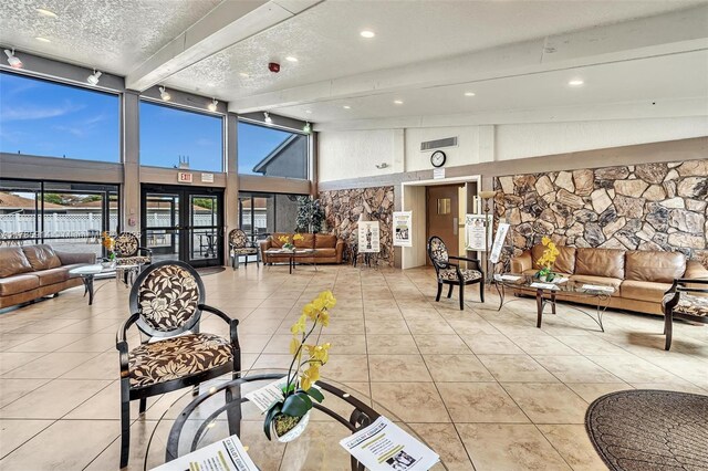 14898 Wildflower Ln Unit 0, Delray Beach, FL 33446 - common area with a towering ceiling, beam ceiling, a textured ceiling, and recessed lighting