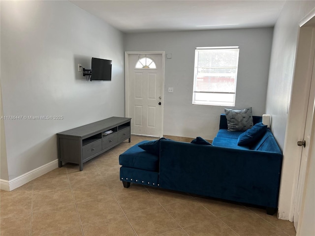 living room featuring baseboards and light tile patterned flooring