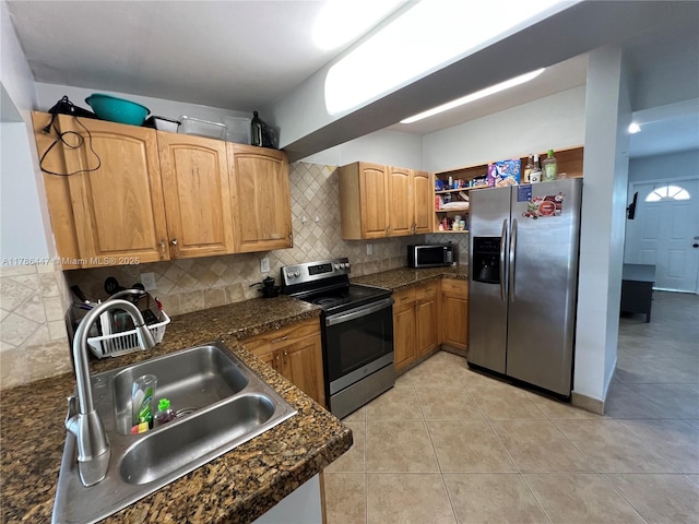 kitchen featuring a sink, tasteful backsplash, appliances with stainless steel finishes, open shelves, and light tile patterned floors