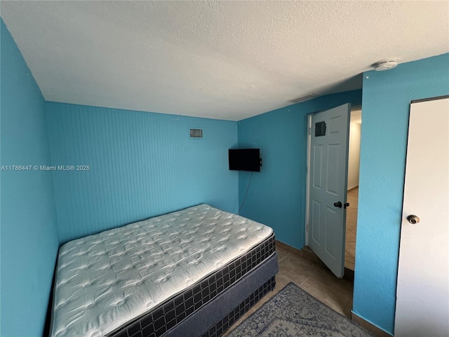 bedroom featuring visible vents and a textured ceiling