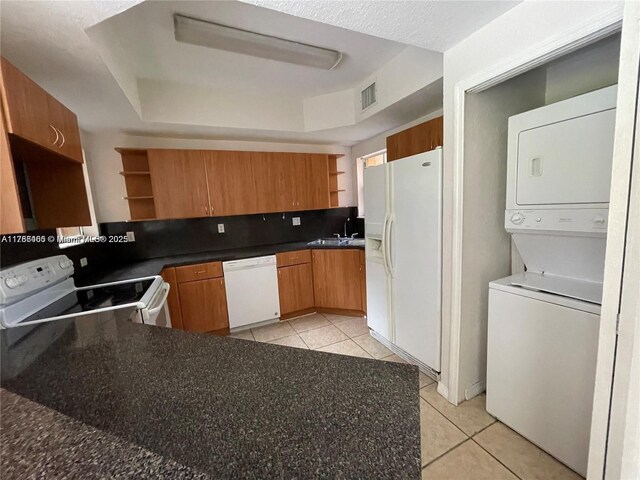 948 SW 6th Ct, Florida City, FL 33034 - kitchen with light tile patterned flooring, visible vents, stacked washer / dryer, white appliances, and open shelves