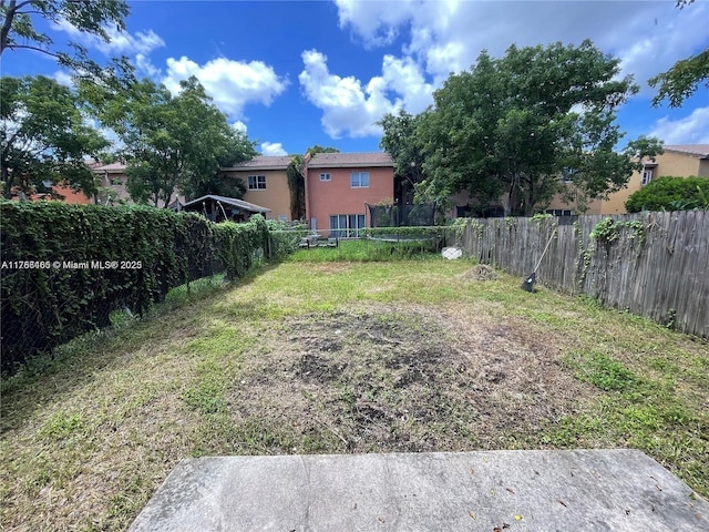 948 SW 6th Ct, Florida City, FL 33034 - view of yard with a trampoline and a fenced backyard