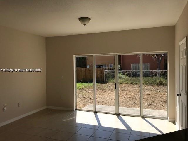 948 SW 6th Ct, Florida City, FL 33034 - interior space with baseboards, a healthy amount of sunlight, and tile patterned floors