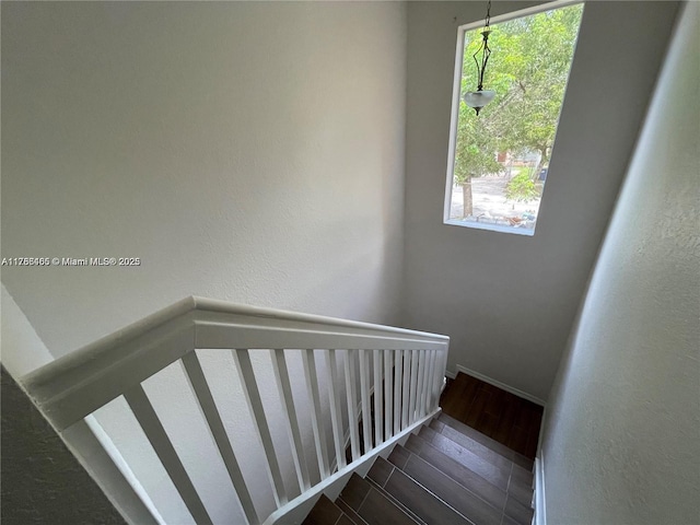 948 SW 6th Ct, Florida City, FL 33034 - stairway with a textured wall, baseboards, a healthy amount of sunlight, and wood finished floors