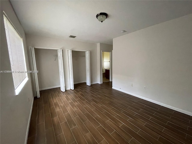 948 SW 6th Ct, Florida City, FL 33034 - unfurnished bedroom featuring baseboards, visible vents, and two closets
