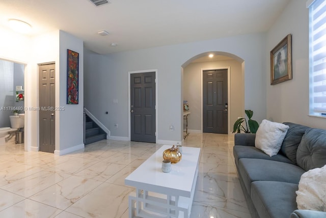 102 NE 23rd Ter, Homestead, FL 33033 - living room with visible vents, marble finish floor, arched walkways, and stairway