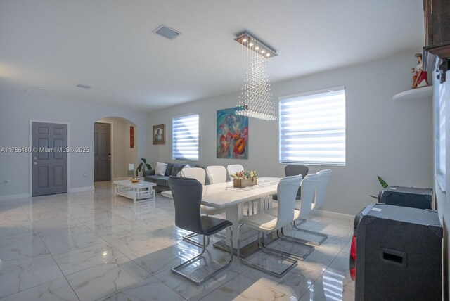 102 NE 23rd Ter, Homestead, FL 33033 - dining room with arched walkways, visible vents, marble finish floor, and baseboards