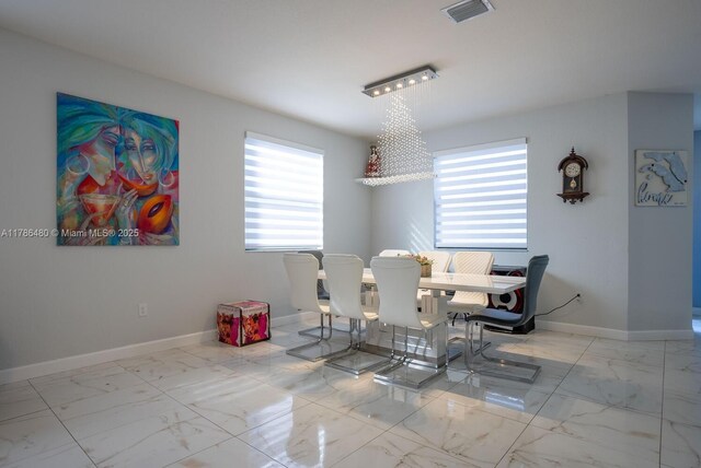 102 NE 23rd Ter, Homestead, FL 33033 - dining space with visible vents, marble finish floor, and baseboards