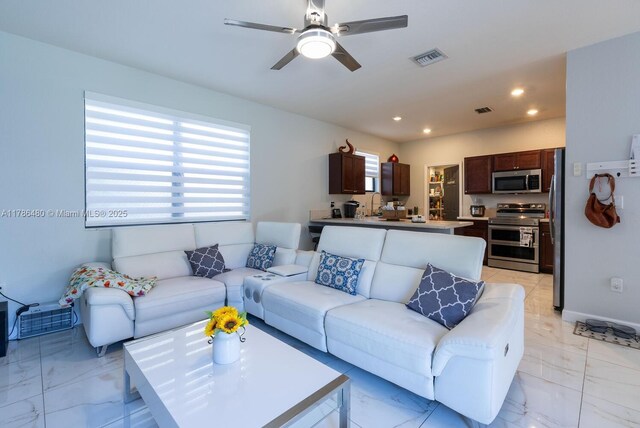 102 NE 23rd Ter, Homestead, FL 33033 - living area featuring plenty of natural light, visible vents, marble finish floor, and ceiling fan