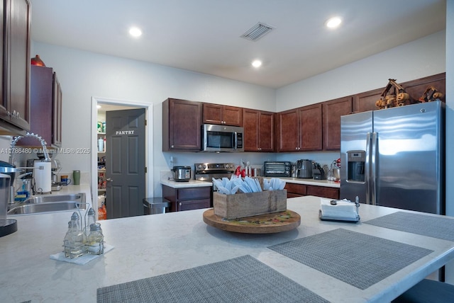 102 NE 23rd Ter, Homestead, FL 33033 - kitchen with stainless steel appliances, a sink, visible vents, recessed lighting, and light countertops