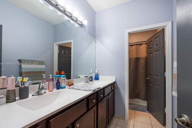102 NE 23rd Ter, Homestead, FL 33033 - bathroom featuring tile patterned floors, a sink, double vanity, and a shower with shower curtain