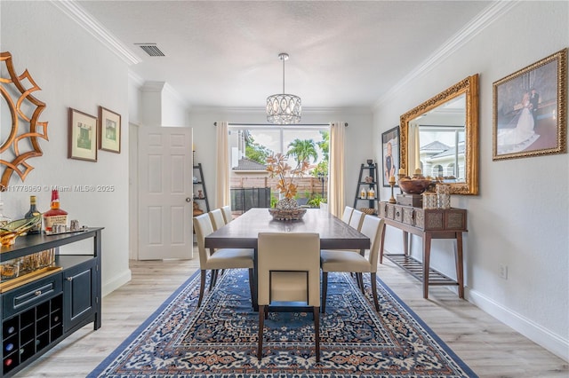1733 SW 151st Pl, Miami, FL 33185 - dining room featuring a chandelier, light wood finished floors, and crown molding