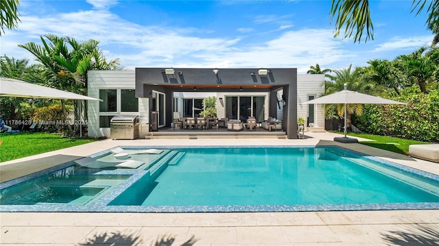 10603 NE 11th Ave, Miami Shores, FL 33138 - back of property with exterior kitchen, an outdoor pool, a patio area, an in-ground hot tub, and outdoor dining space