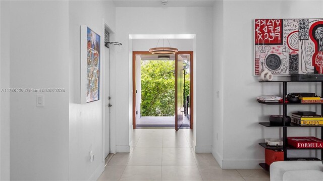 10603 NE 11th Ave, Miami Shores, FL 33138 - hallway featuring baseboards and tile patterned flooring