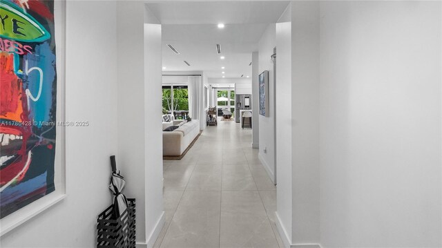 10603 NE 11th Ave, Miami Shores, FL 33138 - corridor featuring baseboards, light tile patterned floors, and recessed lighting
