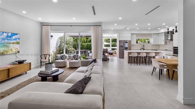 10603 NE 11th Ave, Miami Shores, FL 33138 - living room with recessed lighting and light tile patterned floors