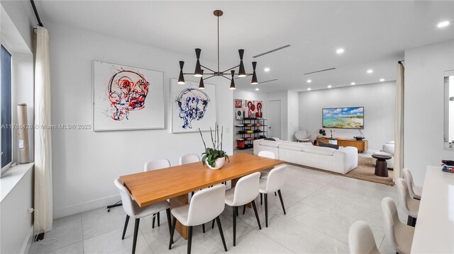 10603 NE 11th Ave, Miami Shores, FL 33138 - dining room featuring light tile patterned flooring, recessed lighting, a chandelier, and baseboards