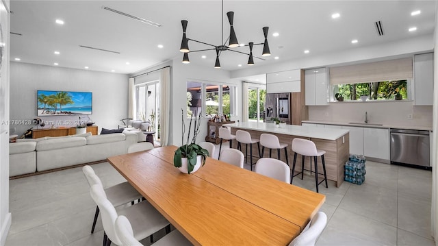 10603 NE 11th Ave, Miami Shores, FL 33138 - dining room featuring healthy amount of natural light, recessed lighting, light tile patterned floors, and a chandelier