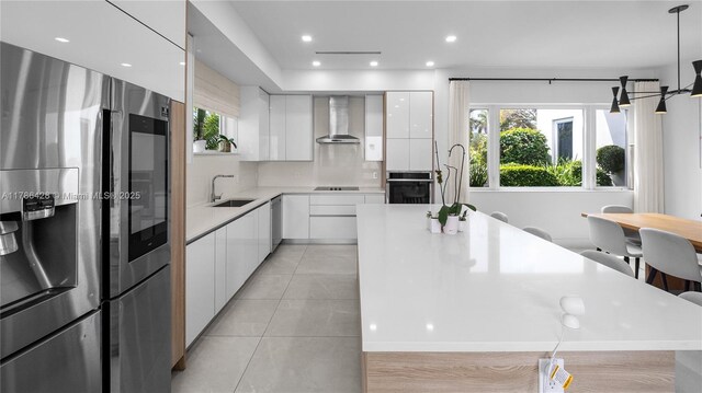 10603 NE 11th Ave, Miami Shores, FL 33138 - kitchen with appliances with stainless steel finishes, wall chimney exhaust hood, a sink, modern cabinets, and recessed lighting