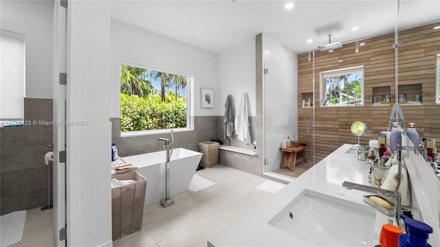 10603 NE 11th Ave, Miami Shores, FL 33138 - bathroom with a shower stall, double vanity, a freestanding bath, tile patterned flooring, and recessed lighting