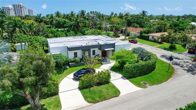 10603 NE 11th Ave, Miami Shores, FL 33138 - view of front of property with stucco siding and view of wooded area