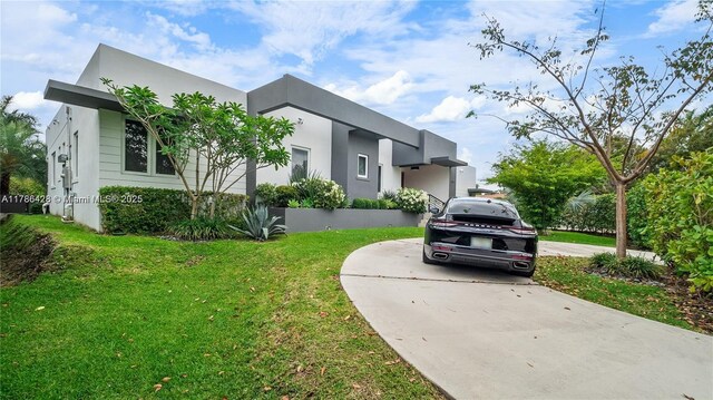 10603 NE 11th Ave, Miami Shores, FL 33138 - view of front of property with a front lawn, stucco siding, and concrete driveway