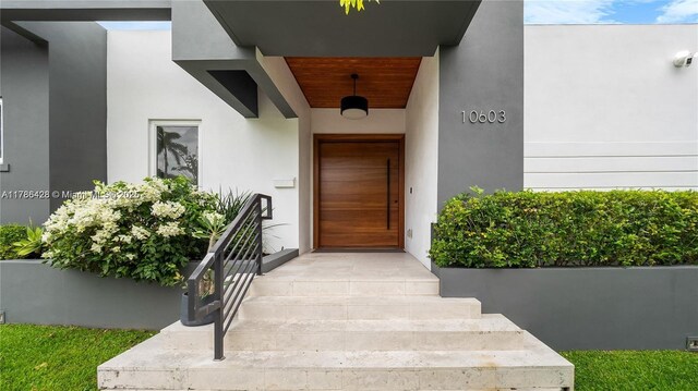 10603 NE 11th Ave, Miami Shores, FL 33138 - doorway to property featuring stucco siding