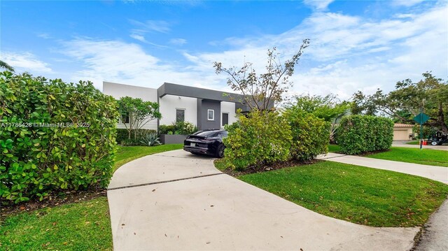 10603 NE 11th Ave, Miami Shores, FL 33138 - view of front of property featuring a front yard and stucco siding