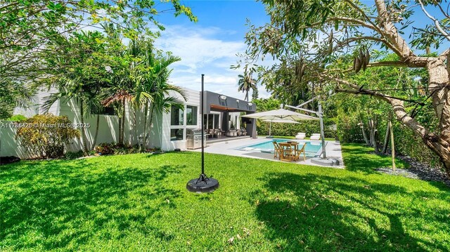 10603 NE 11th Ave, Miami Shores, FL 33138 - view of grassy yard featuring a patio area
