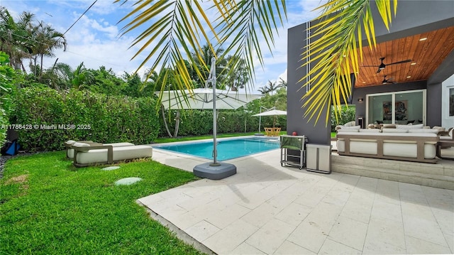 10603 NE 11th Ave, Miami Shores, FL 33138 - view of swimming pool with an outdoor living space, a ceiling fan, a lawn, and a patio