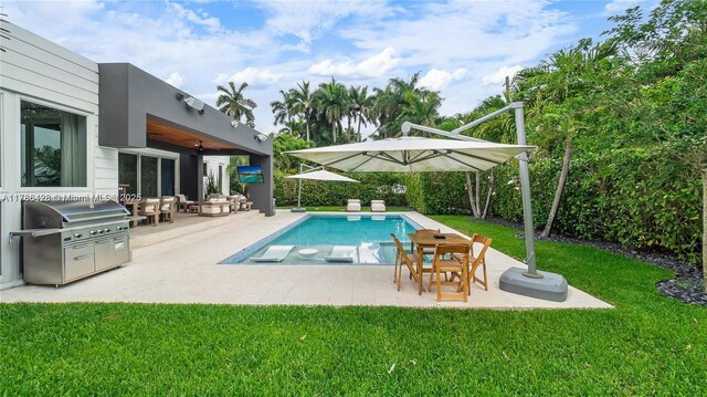 10603 NE 11th Ave, Miami Shores, FL 33138 - view of pool featuring a yard, a patio, a grill, and a ceiling fan