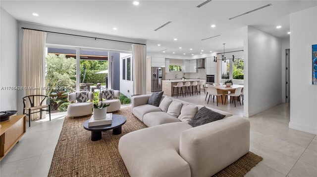 10603 NE 11th Ave, Miami Shores, FL 33138 - living room featuring recessed lighting, light tile patterned flooring, and baseboards