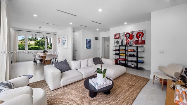 10603 NE 11th Ave, Miami Shores, FL 33138 - living room featuring recessed lighting, light tile patterned floors, and a chandelier