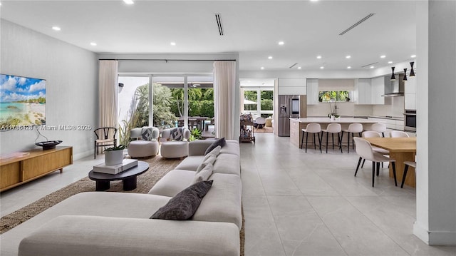 10603 NE 11th Ave, Miami Shores, FL 33138 - living area with recessed lighting and light tile patterned floors