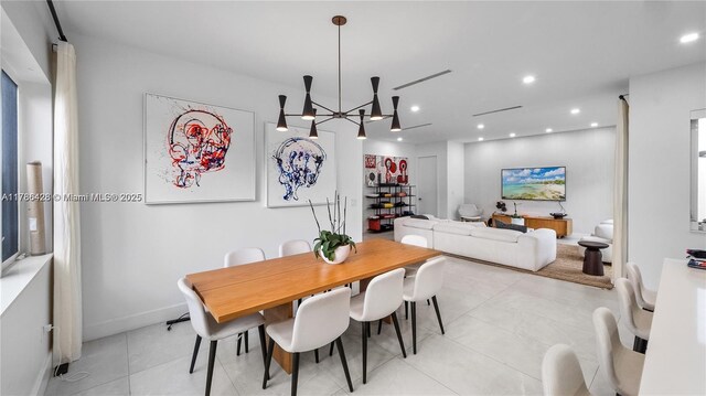 10603 NE 11th Ave, Miami Shores, FL 33138 - dining room with light tile patterned flooring, recessed lighting, a chandelier, and baseboards