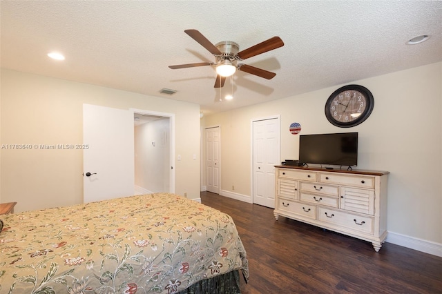 13940 Nesting Way Unit C, Delray Beach, FL 33484 - bedroom featuring dark wood-type flooring, two closets, recessed lighting, ceiling fan, and a textured ceiling