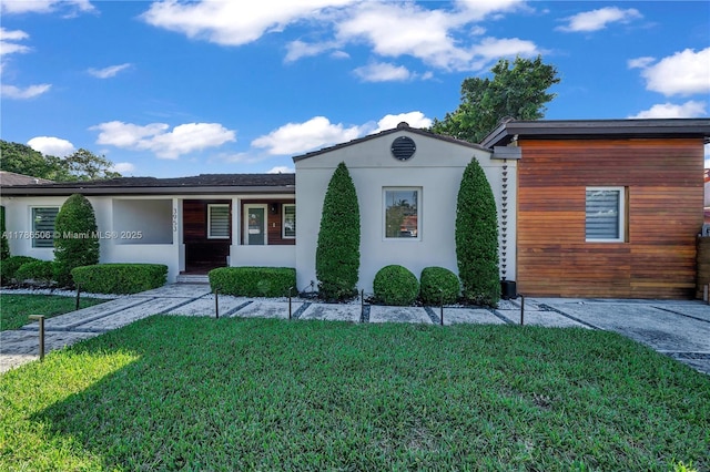 3953 SW 60th Ave, Miami, FL 33155 - view of front of property with a front lawn, stucco siding, and covered porch