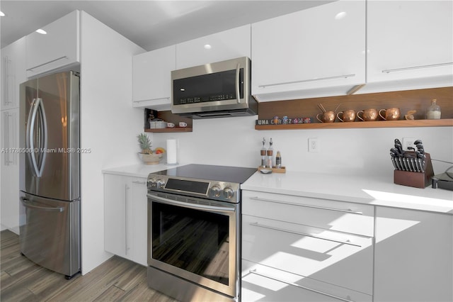 3953 SW 60th Ave, Miami, FL 33155 - kitchen with appliances with stainless steel finishes, open shelves, light wood-style flooring, white cabinetry, and recessed lighting
