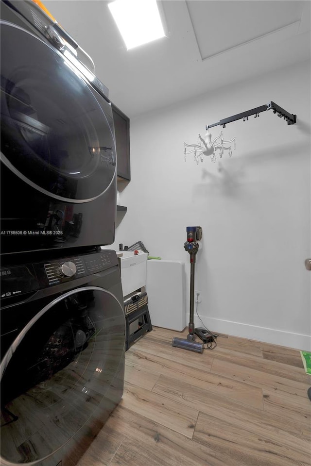 3953 SW 60th Ave, Miami, FL 33155 - laundry area with stacked washer / dryer, wood finished floors, and baseboards