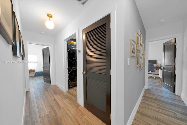 3953 SW 60th Ave, Miami, FL 33155 - hall featuring stacked washer and clothes dryer, light wood-type flooring, and baseboards