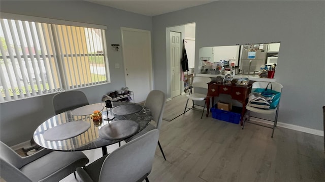 dining area with wood finished floors and baseboards